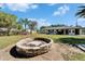 Backyard featuring a fire pit and lush greenery at 1006 Mandalay Dr, Brandon, FL 33511
