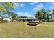 Backyard featuring a fire pit and mature trees at 1006 Mandalay Dr, Brandon, FL 33511