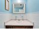 Well-lit bathroom features a sink, mirror, and tiled wall at 1006 Mandalay Dr, Brandon, FL 33511