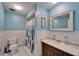 Bathroom featuring a toilet, sink, mirror, and shower with a forest-themed curtain at 1006 Mandalay Dr, Brandon, FL 33511