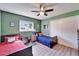 Cozy bedroom with a ceiling fan, two twin beds, and natural light at 1006 Mandalay Dr, Brandon, FL 33511