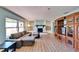 Spacious living room with large windows, fireplace, and a built-in entertainment center at 1006 Mandalay Dr, Brandon, FL 33511
