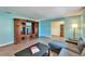 Bright living room featuring a large entertainment center and cozy gray sectional sofa at 1006 Mandalay Dr, Brandon, FL 33511