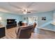 Relaxing living room with TV, desk, and sliding door to outdoor space at 1006 Mandalay Dr, Brandon, FL 33511
