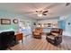 Open-concept living area with wood floors, desk, and sliding glass doors leading to outdoor patio at 1006 Mandalay Dr, Brandon, FL 33511