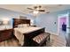 Comfortable main bedroom with a large bed, ceiling fan, and wood-look floors at 1006 Mandalay Dr, Brandon, FL 33511