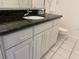 Bathroom vanity with black granite countertop and white cabinetry at 10351 Regal Dr # 18, Largo, FL 33774