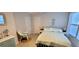 Cozy bedroom featuring a comfortable bed, white furniture and beachy decor at 10351 Regal Dr # 18, Largo, FL 33774