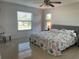 Bright bedroom with a queen bed, ceiling fan, and lots of natural light at 10351 Regal Dr # 18, Largo, FL 33774