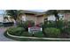 Sign marking the entrance to the Imperial Point Clubhouse with lush landscaping at 10351 Regal Dr # 18, Largo, FL 33774