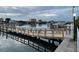 Wooden walkway over the waterfront leads to a boat dock with lit posts at 10351 Regal Dr # 18, Largo, FL 33774