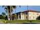 Well-maintained condo building with lush lawn, tropical palms, and balconies on the second story at 10351 Regal Dr # 18, Largo, FL 33774