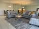 Inviting living room with tile flooring, mirror wall, and stylish furniture at 10351 Regal Dr # 18, Largo, FL 33774