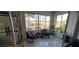 Bright and airy sunroom with tile floors, comfortable seating, and views of the surrounding neighborhood at 10351 Regal Dr # 18, Largo, FL 33774