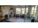 Bright and airy sunroom with tile floors, comfortable seating, and views of the surrounding neighborhood at 10351 Regal Dr # 18, Largo, FL 33774