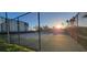 A community tennis court with the morning sun shining through the net of the fence at 10351 Regal Dr # 18, Largo, FL 33774