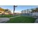 Well-maintained tennis court surrounded by lush greenery and a secure fence at 10351 Regal Dr # 18, Largo, FL 33774