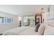 Bright bedroom featuring a mirrored closet, built-in shelves, and a comfortable bed at 10686 110Th Ln, Largo, FL 33778