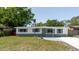 Well-maintained single-story home with updated gray and white exterior paint and landscaping at 10686 110Th Ln, Largo, FL 33778