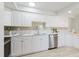 Bright kitchen featuring white cabinets, stainless steel appliances, and quartz countertops at 10686 110Th Ln, Largo, FL 33778