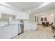 Bright, updated kitchen featuring white cabinetry, stainless appliances, and breakfast bar seating at 10686 110Th Ln, Largo, FL 33778