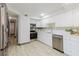 Bright kitchen featuring white cabinets, stainless steel appliances, and quartz countertops at 10686 110Th Ln, Largo, FL 33778