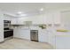 Bright kitchen featuring white cabinets, stainless steel appliances, and quartz countertops at 10686 110Th Ln, Largo, FL 33778