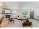 Bright living room features a stone fireplace, light wood floors, and comfortable seating arrangement at 10686 110Th Ln, Largo, FL 33778