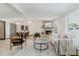 Open concept living room with a cozy stone fireplace, dining area, and lots of natural light at 10686 110Th Ln, Largo, FL 33778