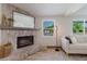 Cozy living room with a stone fireplace, mantel mirror, and comfortable seating at 10686 110Th Ln, Largo, FL 33778