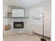Stone fireplace with a mirror above the mantel in this light and airy living room at 10686 110Th Ln, Largo, FL 33778
