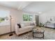 Bright living room with stylish sofa, modern floor lamp, and decorative rug at 10686 110Th Ln, Largo, FL 33778