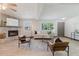 Bright living room features a stone fireplace, light wood floors, and comfortable seating arrangement at 10686 110Th Ln, Largo, FL 33778