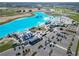 Aerial view of the community lagoon with beachfront amenities, recreation areas, and convenient parking at 10727 Penny Gale Loop, San Antonio, FL 33576