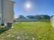 View of the spacious backyard with healthy lawn, privacy fence, and room for outdoor recreation at 10727 Penny Gale Loop, San Antonio, FL 33576
