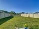 Expansive backyard with lush green grass and a privacy fence at 10727 Penny Gale Loop, San Antonio, FL 33576