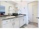 Bathroom featuring double sinks, granite counters, and white cabinetry at 10727 Penny Gale Loop, San Antonio, FL 33576