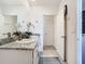 Bright bathroom featuring a double vanity with stone countertop and modern fixtures at 10727 Penny Gale Loop, San Antonio, FL 33576