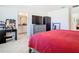 Bright bedroom featuring plush carpet, a TV, and an ensuite bathroom at 10727 Penny Gale Loop, San Antonio, FL 33576