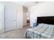 The bedroom features a simple design with a comfortable bed and easy access to the bathroom and office at 10727 Penny Gale Loop, San Antonio, FL 33576
