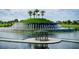 Beautiful fountain on a small island, offering a peaceful retreat for homeowners, nestled in a tranquil lake at 10727 Penny Gale Loop, San Antonio, FL 33576