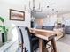 Dining room featuring a modern chandelier, a wooden table and gray chairs, conveniently located near the kitchen at 10727 Penny Gale Loop, San Antonio, FL 33576