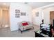 Comfortable sitting area in hallway provides a cozy space with neutral carpet and bright paint at 10727 Penny Gale Loop, San Antonio, FL 33576