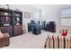 Spacious office area featuring custom storage, comfortable seating, and plenty of natural light for working from home at 10727 Penny Gale Loop, San Antonio, FL 33576