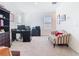The home office features a large desk with a printer and an additional seating area for relaxation at 10727 Penny Gale Loop, San Antonio, FL 33576