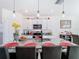 Bright kitchen features a granite island with seating, pendant lighting, stainless appliances, and white cabinetry at 10727 Penny Gale Loop, San Antonio, FL 33576