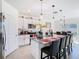 Bright kitchen with stainless steel appliances, white cabinets, granite countertops, and breakfast bar seating at 10727 Penny Gale Loop, San Antonio, FL 33576