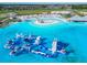 Aerial view of blue water lagoon with play structure in distance, making it an ideal recreational area at 10727 Penny Gale Loop, San Antonio, FL 33576