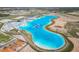 The community lagoon includes an inflatable waterpark, white sand beach, and many lounge chairs under shade at 10727 Penny Gale Loop, San Antonio, FL 33576