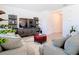 Comfortable living room with modern furniture, TV, accent shelves, and soft neutral colors throughout at 10727 Penny Gale Loop, San Antonio, FL 33576